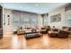 Bright living room featuring hardwood floors, neutral furniture, and an area rug at 4965 Huntwick Pl, Highlands Ranch, CO 80130