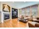 Cozy living room featuring hardwood floors, fireplace, and natural light at 4965 Huntwick Pl, Highlands Ranch, CO 80130