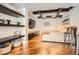 Contemporary living room with dark wood floors, custom shelving, recessed lighting, and a comfortable sofa at 4965 Huntwick Pl, Highlands Ranch, CO 80130