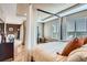 Lovely main bedroom features many windows, a ceiling fan, hardwood floors and a canopy bed at 4965 Huntwick Pl, Highlands Ranch, CO 80130