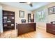 Inviting office features a large desk, hardwood floors, and natural light from the window at 4965 Huntwick Pl, Highlands Ranch, CO 80130