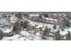 Aerial view of snow-covered neighborhood showcasing the property's location, landscaping, and surrounding community at 2067 E Phillips Pl, Centennial, CO 80122