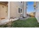Side yard with artificial turf and access to wood deck stairs at 2067 E Phillips Pl, Centennial, CO 80122