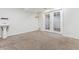 Finished basement area with sink, door to outside, and plush carpeting at 2067 E Phillips Pl, Centennial, CO 80122
