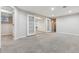 Spacious basement area with neutral carpet, white walls, and french doors at 2067 E Phillips Pl, Centennial, CO 80122