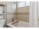 Bathroom featuring a tiled bathtub and shower combination with a small plant for decoration at 2067 E Phillips Pl, Centennial, CO 80122