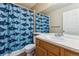 Bathroom features a shark-themed shower curtain, sink, and vanity with a large mirror at 2067 E Phillips Pl, Centennial, CO 80122