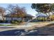 Community building featuring a quaint gray exterior, sidewalk, and mature trees at 2067 E Phillips Pl, Centennial, CO 80122