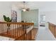 Hallway leading to upstairs features a built-in desk area with natural light and a ceiling fan at 2067 E Phillips Pl, Centennial, CO 80122