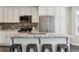 Updated kitchen with granite countertops, stainless steel appliances, and seating at the center island at 2067 E Phillips Pl, Centennial, CO 80122