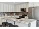 Updated kitchen island with granite countertops, stainless steel appliances, and breakfast bar seating at 2067 E Phillips Pl, Centennial, CO 80122