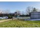 Tennis court with surrounding fence and benches at 2067 E Phillips Pl, Centennial, CO 80122