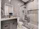 Bathroom with a glass shower, tiled walls, and a sleek vanity with undermount sink and large, illuminated mirror at 29780 E 162Nd Ave, Brighton, CO 80603