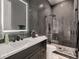 Modern bathroom with a black marble wall, a glass-enclosed shower, and dark wood cabinets at 29780 E 162Nd Ave, Brighton, CO 80603