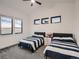 Cozy bedroom with two beds, a ceiling fan, and a window with a view at 29780 E 162Nd Ave, Brighton, CO 80603