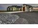 Stunning home exterior with modern garage doors, professional landscaping, and beautiful architectural lighting at 29780 E 162Nd Ave, Brighton, CO 80603