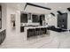 Stylish kitchen with a large island, sleek black cabinetry, and stainless steel appliances at 29780 E 162Nd Ave, Brighton, CO 80603