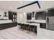 Modern kitchen with a spacious island, elegant black cabinets, and white subway tile backsplash at 29780 E 162Nd Ave, Brighton, CO 80603