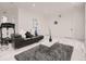 Bright living room with leather sofas, a modern coffee table, and sleek marble-look floors at 29780 E 162Nd Ave, Brighton, CO 80603