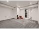 This empty living room has carpeted floors, recessed lighting, and access to an attached bathroom at 29780 E 162Nd Ave, Brighton, CO 80603