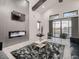 Cozy living room with a fireplace, high ceilings with dark wood beams, marble floors, and scenic window views at 29780 E 162Nd Ave, Brighton, CO 80603