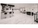 Expansive living room featuring a bar area, workout equipment, and stylish marble-look flooring at 29780 E 162Nd Ave, Brighton, CO 80603