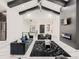 Elegant living room features vaulted ceilings, black beams, a modern fireplace, and plush seating at 29780 E 162Nd Ave, Brighton, CO 80603