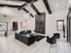 Open living room with a modern fireplace, high ceilings, dark wood beams, and elegant marble floors at 29780 E 162Nd Ave, Brighton, CO 80603