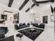 Open floor plan featuring living room with high ceilings, dark wood beams, marble floors, and modern furnishings at 29780 E 162Nd Ave, Brighton, CO 80603