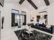 Bright living room showcasing high ceilings, dark wood beams, marble floors, and sliding doors leading to backyard at 29780 E 162Nd Ave, Brighton, CO 80603