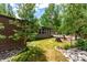 Landscaped backyard with mature trees and fire pit seating at 85 Revett Dr # 15, Breckenridge, CO 80424