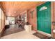 Hallway featuring wood plank walls, a tile floor and a green exterior door with a decorative half moon window at 85 Revett Dr # 15, Breckenridge, CO 80424