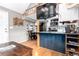 Open kitchen with wood floors, an island, and modern appliances at 85 Revett Dr # 15, Breckenridge, CO 80424