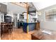Open kitchen with wood floors, an island, and modern appliances at 85 Revett Dr # 15, Breckenridge, CO 80424