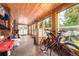 Sunroom featuring wood paneling, tile floor and multiple windows allowing the natural light to flow in at 85 Revett Dr # 15, Breckenridge, CO 80424