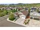 An aerial view showcases a well-maintained home with a three-car garage in a beautiful community at 6013 Eldora St, Golden, CO 80403