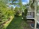 Relaxing backyard with green grass, shrubs, and a patio sitting area at 6013 Eldora St, Golden, CO 80403