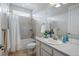 Bright bathroom with a shower-tub combination, neutral tile, and a white vanity at 6013 Eldora St, Golden, CO 80403