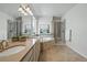 A luxurious bathroom featuring a double vanity, soaking tub, separate shower, and stylish fixtures at 6013 Eldora St, Golden, CO 80403