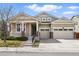 Charming exterior of home with a porch, well-maintained lawn, and two car garage at 6013 Eldora St, Golden, CO 80403