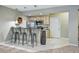 Stylish kitchenette features bar seating, stainless steel appliances, and contemporary lighting at 6013 Eldora St, Golden, CO 80403