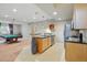 Open concept kitchenette with modern appliances, bar, and seamless flow into the recreation area at 6013 Eldora St, Golden, CO 80403