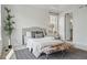 Bright main bedroom with a comfortable bed, stylish decor, and a view into the ensuite bathroom at 6013 Eldora St, Golden, CO 80403