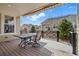 Relaxing covered patio featuring an awning, dining set, and views of the landscaped backyard at 6013 Eldora St, Golden, CO 80403
