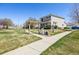 Well-maintained home exterior with landscaped lawn, sidewalk, and a partial pergola in a desirable neighborhood at 20535 E 47Th Ave, Denver, CO 80249
