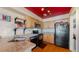 Functional kitchen with wooden cabinets, tile countertops, and essential appliances at 20535 E 47Th Ave, Denver, CO 80249