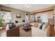 Bright living room featuring neutral walls, hardwood floors, and a view into the dining area at 20535 E 47Th Ave, Denver, CO 80249