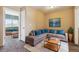 Comfortable living room features a large sectional sofa, gray carpet, and ample natural light at 20535 E 47Th Ave, Denver, CO 80249