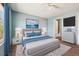 Serene main bedroom featuring cool blue tones, plush carpet, and an adjacent ensuite bathroom at 20535 E 47Th Ave, Denver, CO 80249