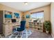 Home office featuring built-in bookshelves, a comfortable workspace, and natural light at 20535 E 47Th Ave, Denver, CO 80249